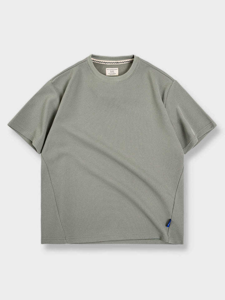 ゆったりとしたフィット感のワッフル柄ワイドフィット半袖Tシャツの全体ビュー。高品質の無地のコットン生地と精細なワッフル柄が特徴で、通気性と快適さを提供します。