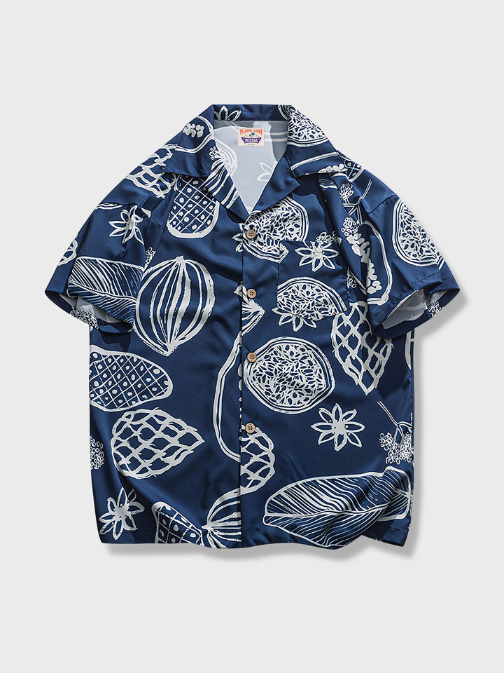 PLAME AUBEの深い青色ベースのグラフィティ風パターンシャツ、果物と木の要素のデザイン、ポリエステル100％、白背景